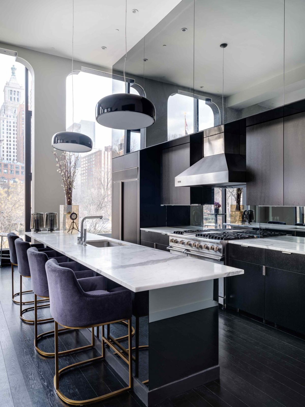 The open-plan chef's kitchen with fixtures manufactured by Sherle Wagner