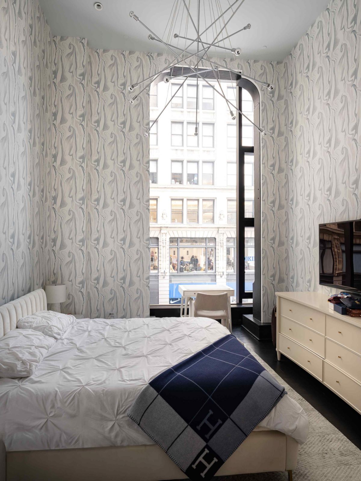 Art Deco-style mirror wallpaper in the primary bedroom