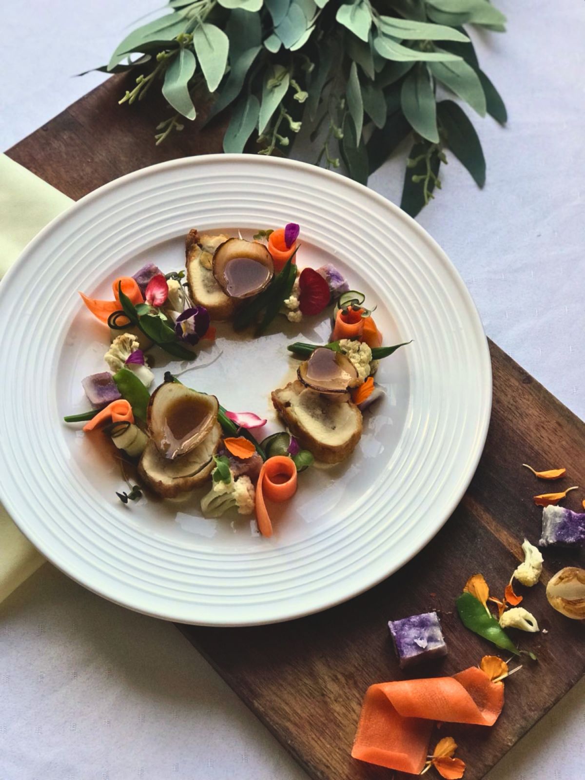 Chicken Galantine with pickled vegetables, onion petals, purple kamote, charred onion and whiskey jus