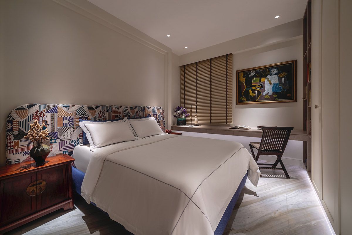 A custom headboard brings a dynamic touch to this guest room