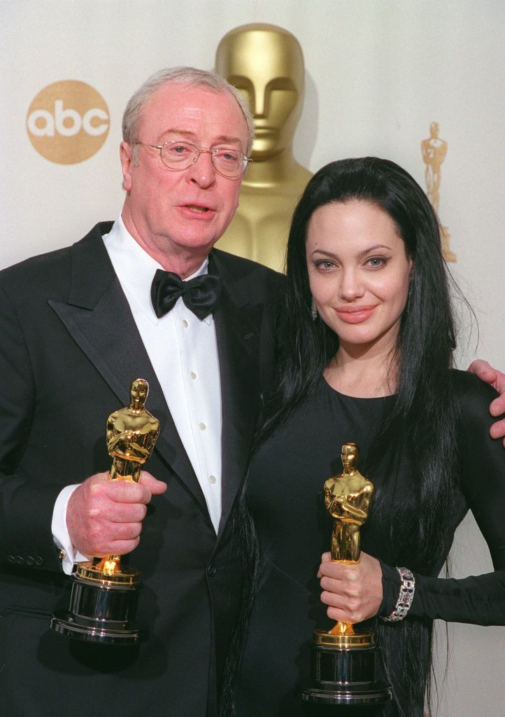 387049 04: Michael Caine, who won Best Supporting Actor, and Angelina Jolie, who won Best Supporting Actress, pose for a photograph with their Oscars March 26, 2001 backstage of the awards show in Los Angeles, CA. (Photo HO/AMPAS)