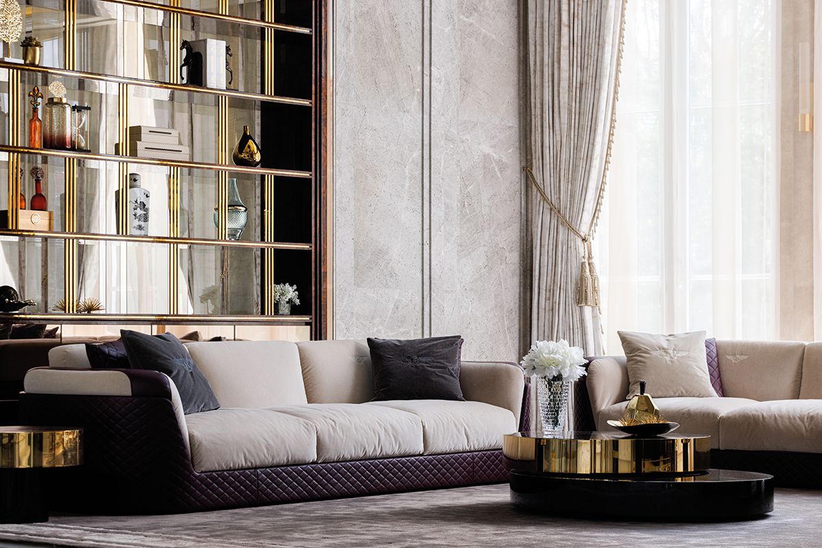The gold trim of the Minotti coffee table echoes the sheen of the display shelves in the living room