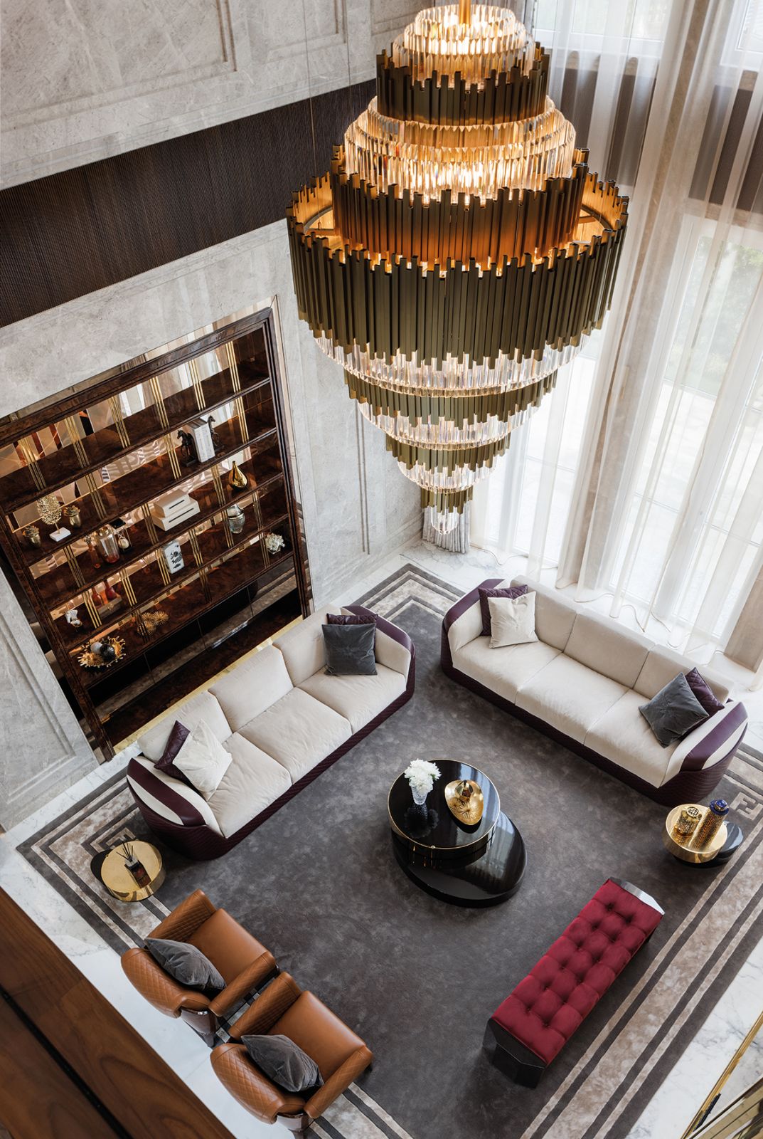 A top-down view of the formal living room, which features Chorley sofas and Sherwood armchairs from Bentley Home, a Minotti Benson coffee table and a bench from Giorgio Collection