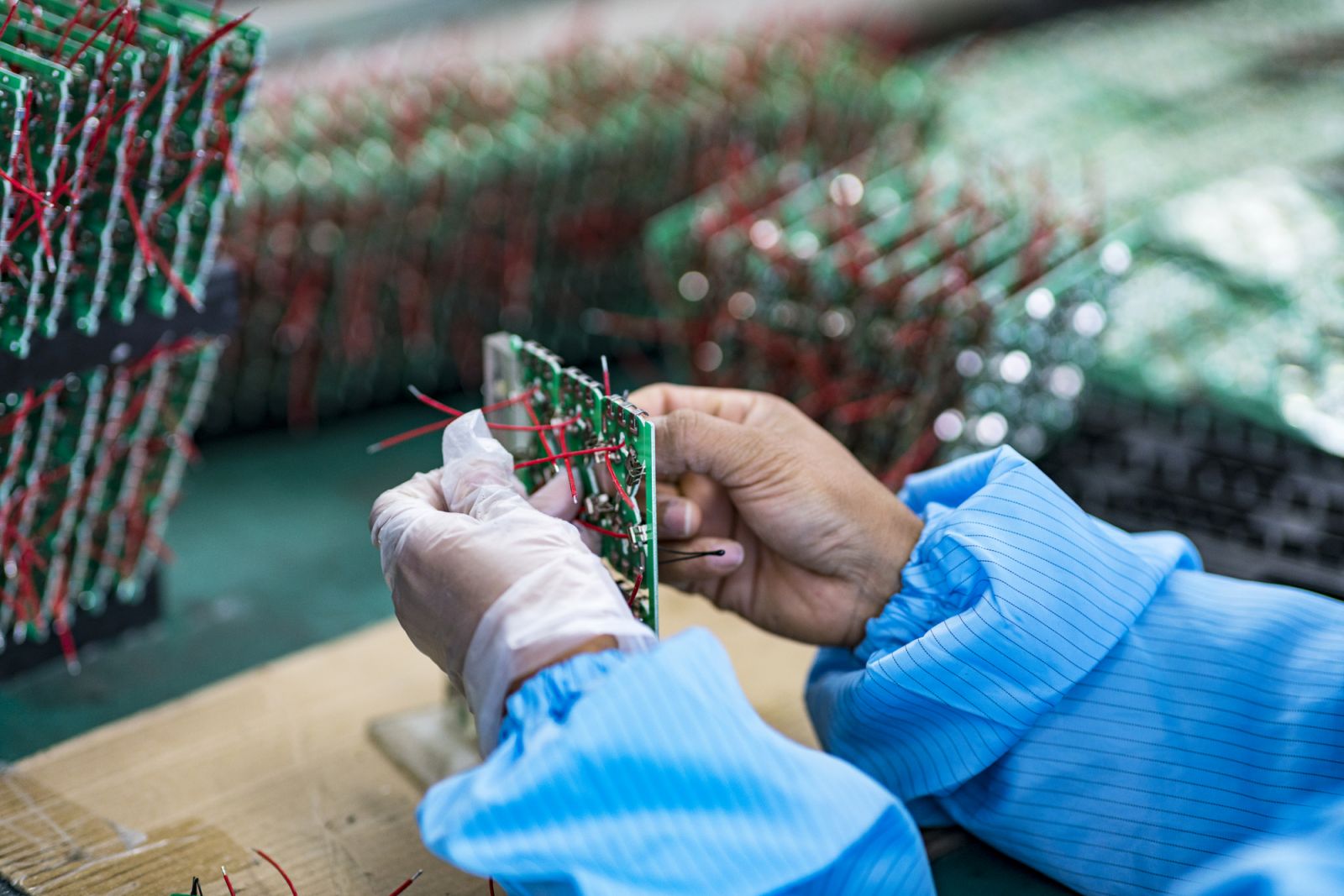 A worker operating to a circuit board for electrical appliances at a electronics factory in China (Photo: Getty Images/owngarden)