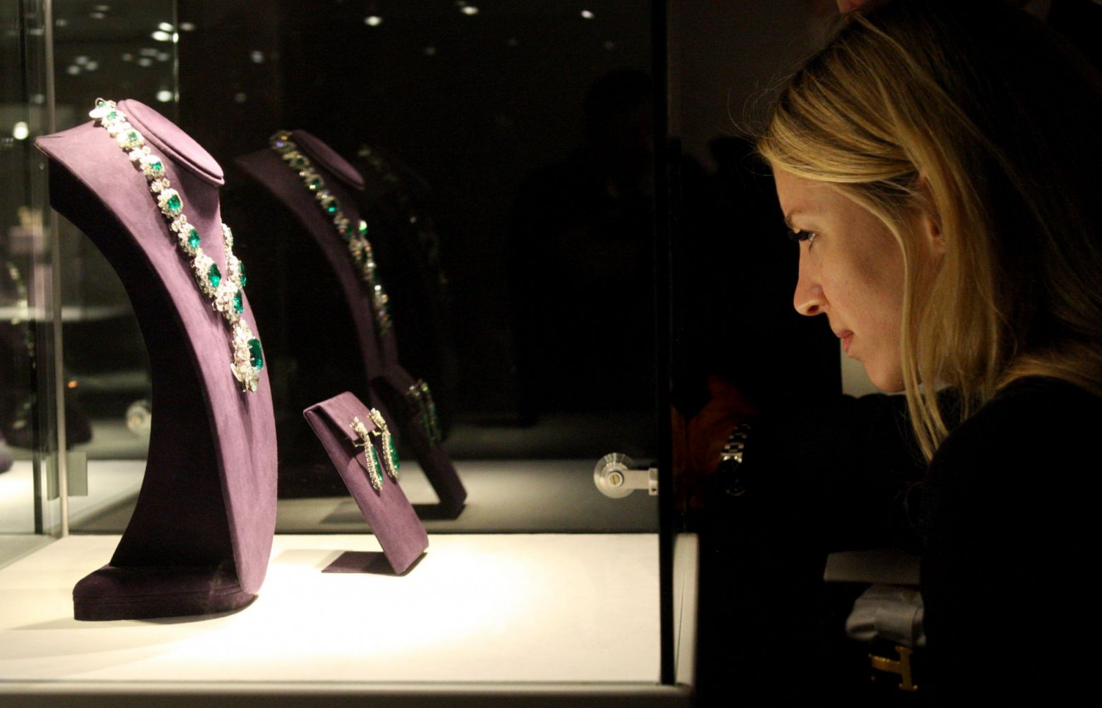 Thea Darricotte, a fan of the late Elizabeth Taylor, looks at an emerald and diamond necklace , exhibited at Christie's, London, before being auctioned in New York and London. (Photo by Georgie Gillard/PA Images via Getty Images)