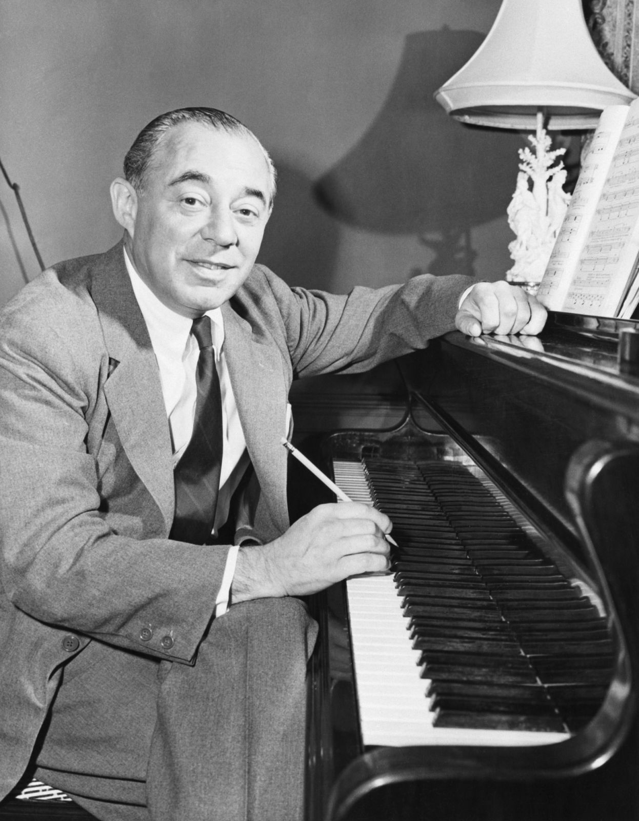 A portrait of composer Richard Rodgers sits at his piano creating a musical score for the forthcoming NBC television series Victory at Sea. This will be Rodgers first score for television.