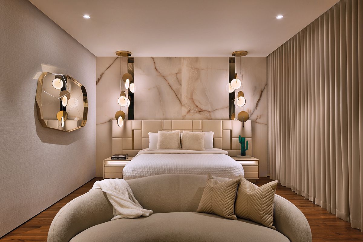 The disc-like form of the Lee Broom Eclipse pendant lights counteracts the angular shapes of the other furnishings in this bedroom room