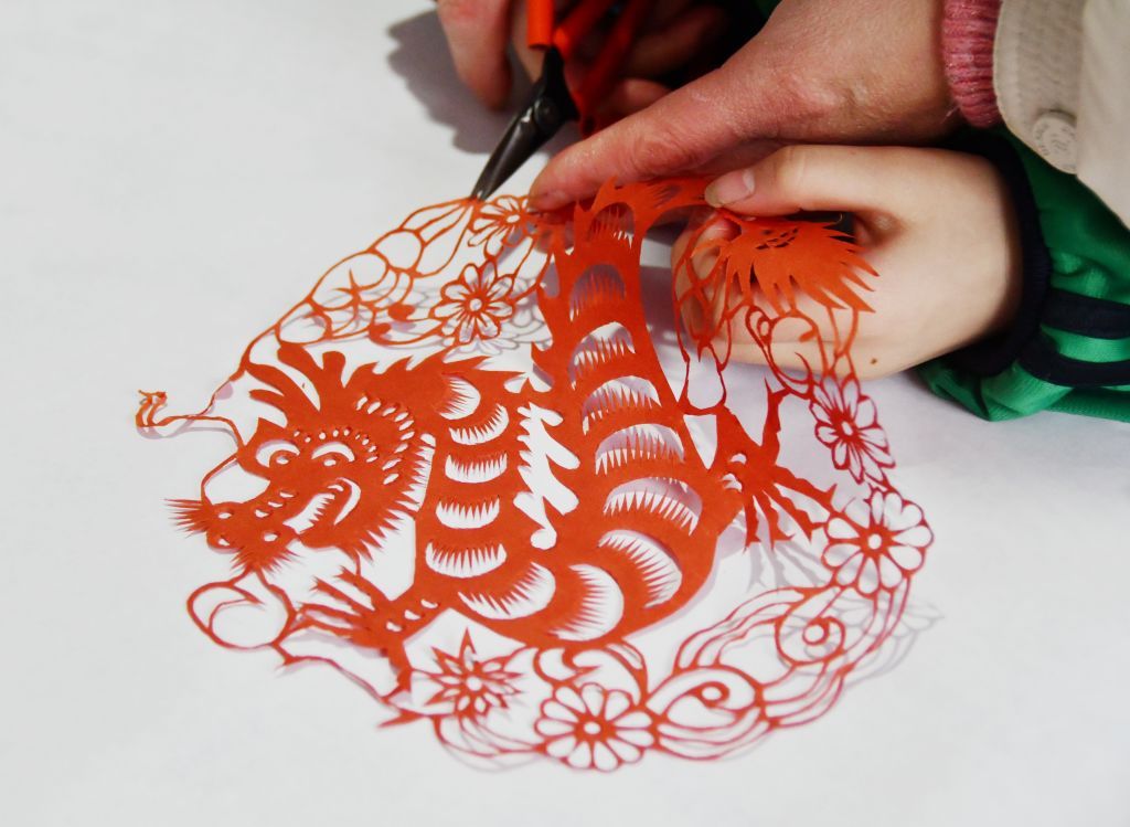 HANDAN, CHINA - JANUARY 13, 2024 - Students create paper-cut works themed "Year of the Dragon" in Handan, Hebei province, China, Jan 13, 2024. (Photo credit should read CFOTO/Future Publishing via Getty Images)