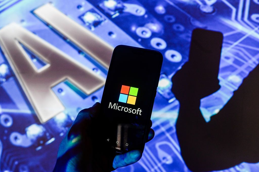 POLAND - 2024/01/17: In this photo illustration, a Microsoft logo is displayed on a smartphone with Artificial Intelligence (AI) symbol in the background. (Photo Illustration by Omar Marques/SOPA Images/LightRocket via Getty Images)
