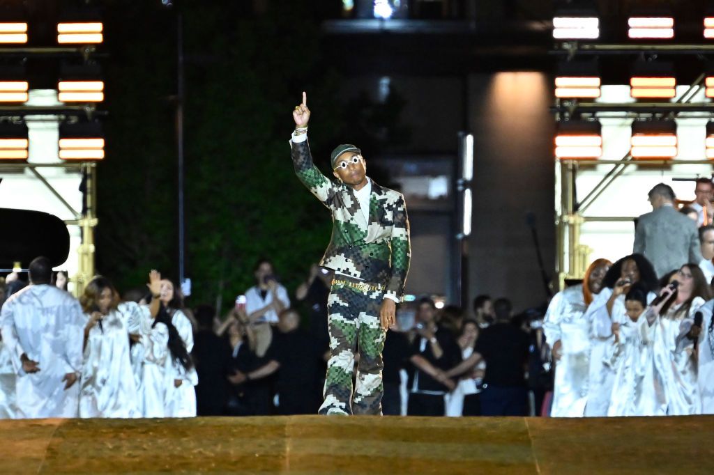 PARIS, FRANCE - JUNE 20: (EDITORIAL USE ONLY - For Non-Editorial use please seek approval from Fashion House) Louis Vuitton Men's Creative Director Pharrell Williams acknowledges the applause of the audience after the Louis Vuitton Menswear Spring/Summer 2024 show as part of Paris Fashion Week on June 20, 2023 in Paris, France. (Photo by Aurelien Meunier/Getty Images)
