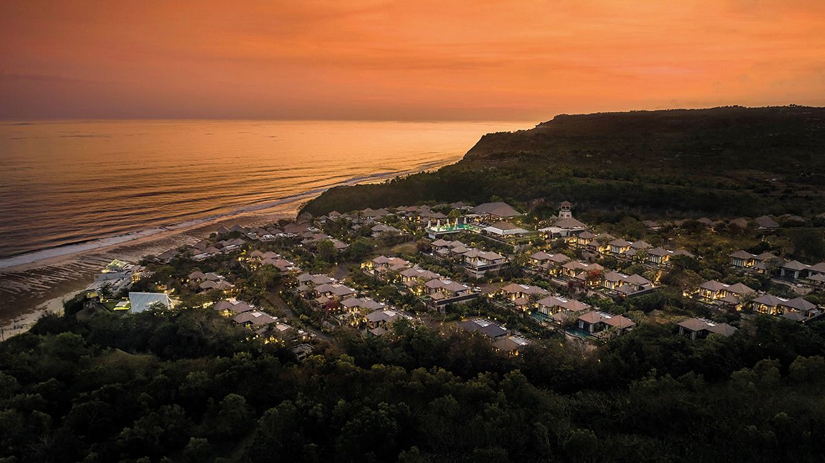 An aerial view of the Umana Bali beachfront resort at sunset