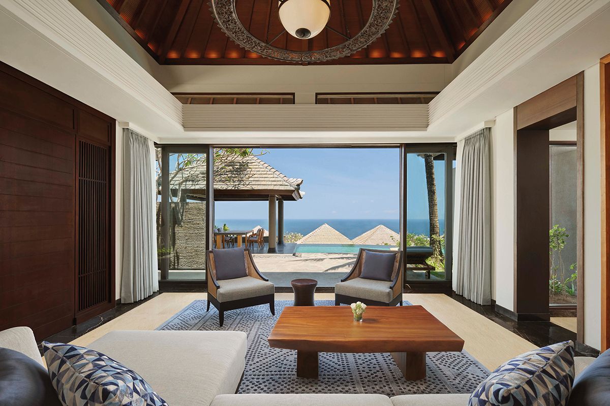 The living room of Umana Bali’s Pool Villa features blue elements that mirror the view