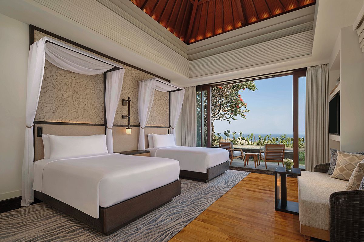 The Umana Bali Pool Villa’s second bedroom features canopied twin beds
