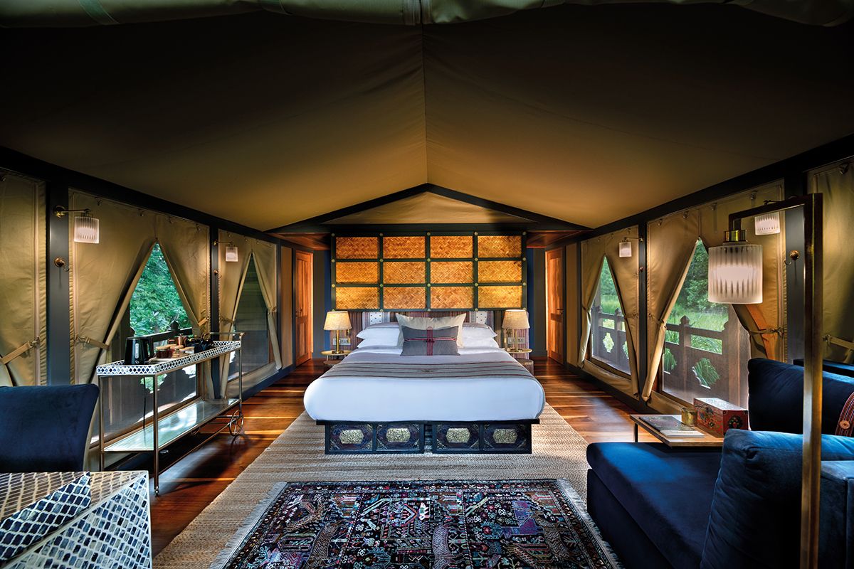 The design of the tented suite’s bedroom at Punakha River Lodge pays tribute to traditional Bhutanese architecture