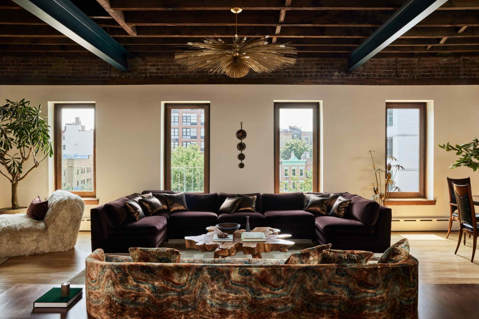 The exposed wood beamed ceiling paired with a touch of Art Deco opulence