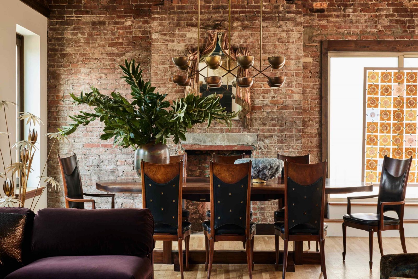 A 19th century French Trompe L'oeil carved mirror, and a Higgins Rondelay glass panelled screen in the warm dining area