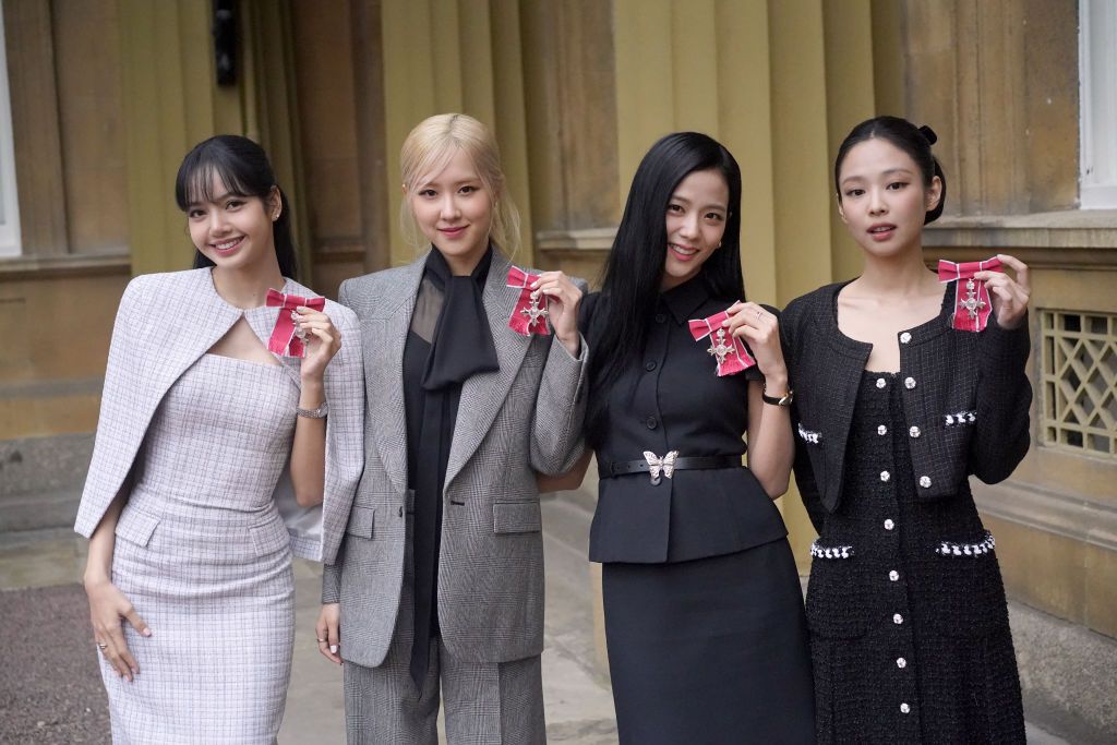 LONDON, ENGLAND - NOVEMBER 22: (left to right) Lisa (Lalisa Manoban), Rose (Roseanne Park), Jisoo Kim and Jennie Kim, from the K-Pop band Blackpink pose with their Honorary MBEs (Members of the Order of the British Empire), awarded to them in recognition of the band's role as COP26 advocates for the COP26 Summit in Glasgow 2021 on November 22, 2023 in London, England. King Charles III conducted the special Investiture ceremony in the presence of the President of South Korea, Yoon Suk Yeol, and his wife, Kim