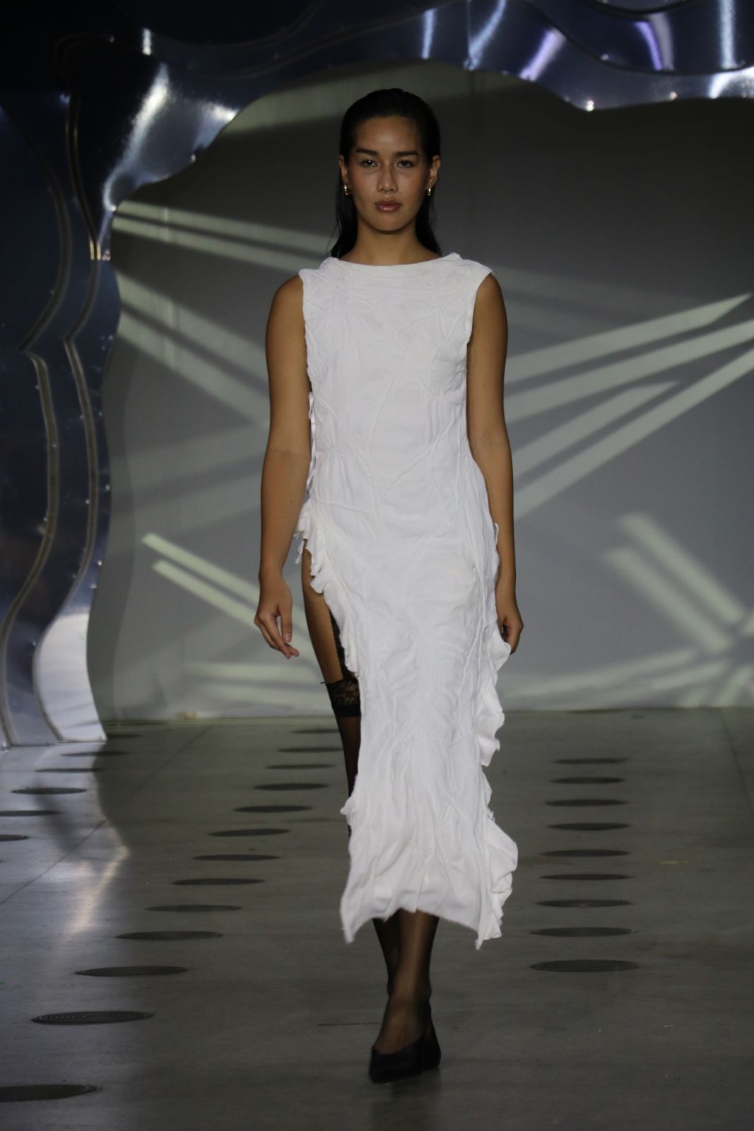 A white dress with a thigh-high slit from the [dare to stare] collection by Ar Valdez