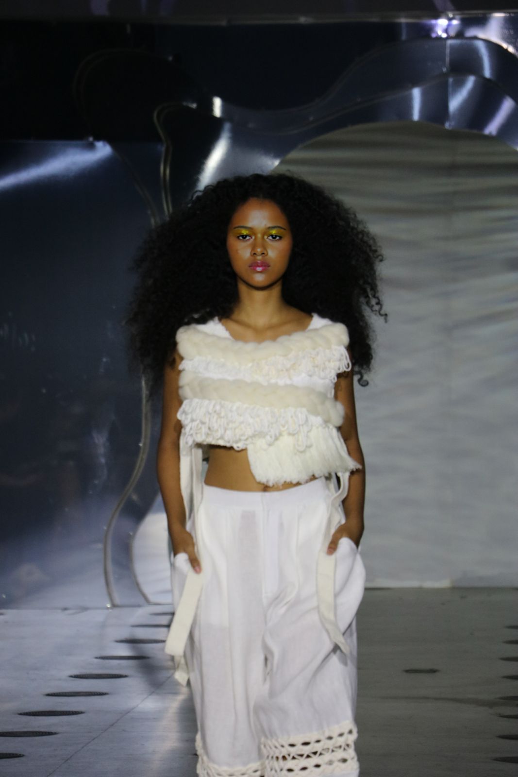 A white two-piece outfit with fur trimming from the Desiderium collection by Nyles Tan
