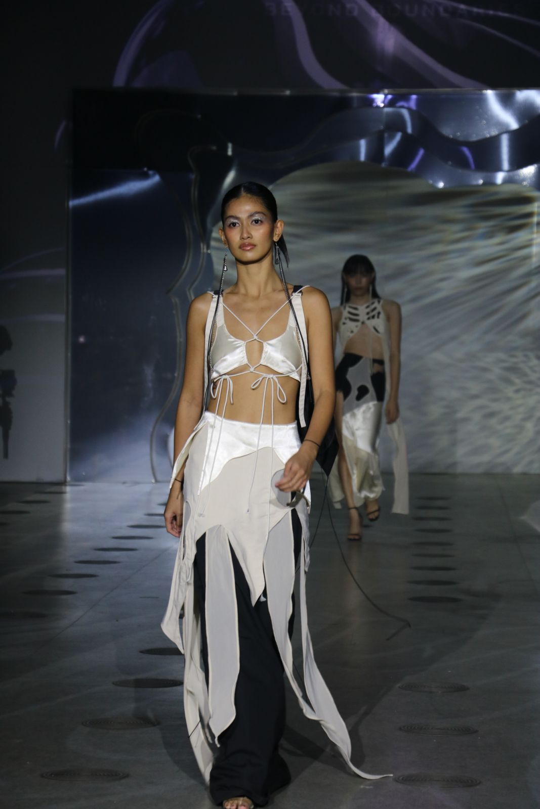 A deconstructed white and black ensemble from the Outcast collection by Reinjamin Riodique