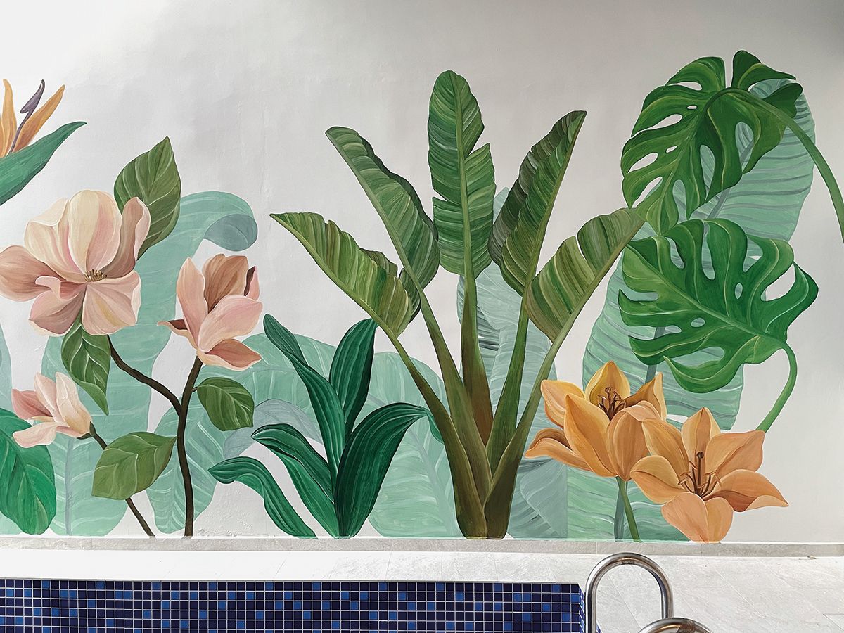 This botanical mural by The Ochre Home adds tropical pizzazz to a poolside setting