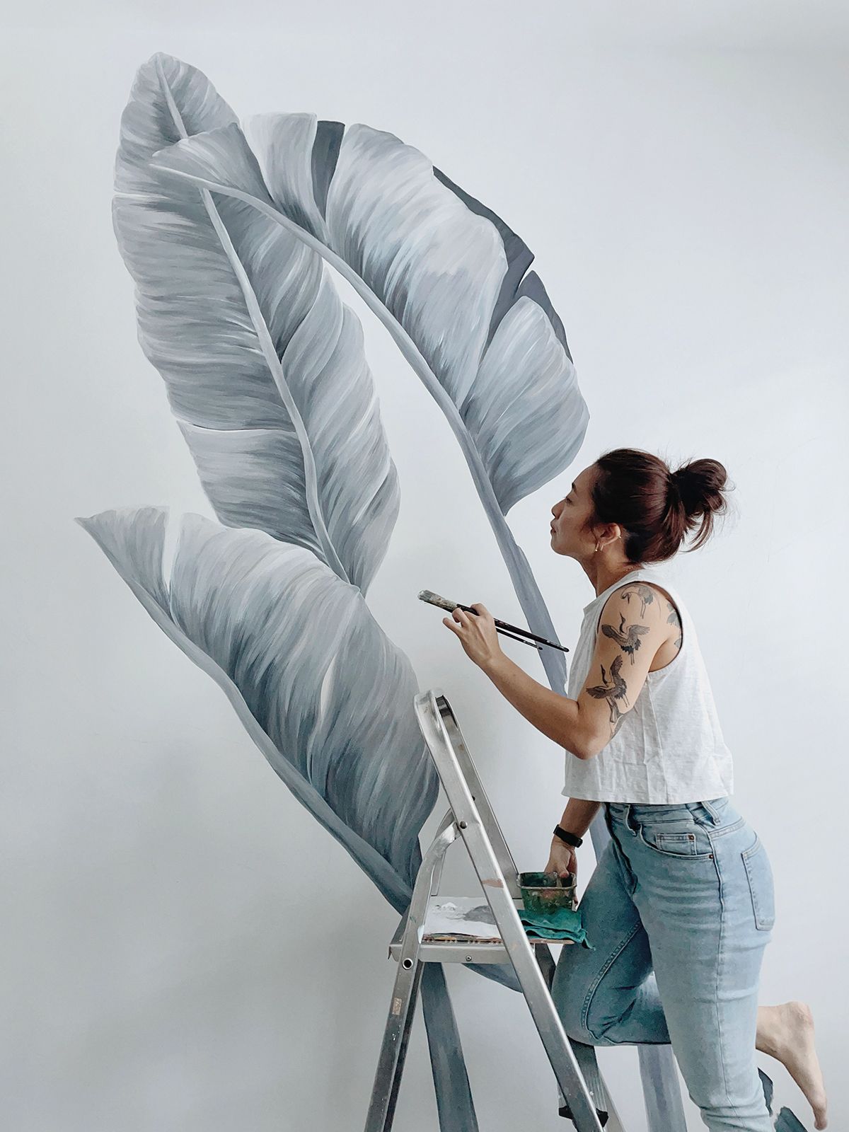 Toh in the process of bringing one of her signature residential murals to life