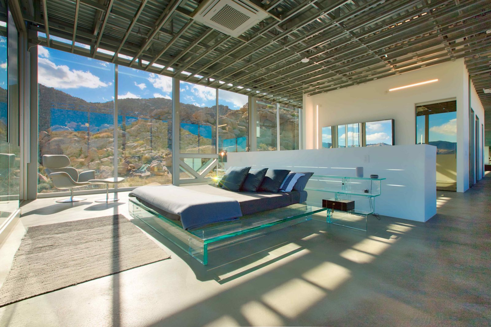 The primary bedroom with the two-tonne sold glass bed (Photo: Masek)