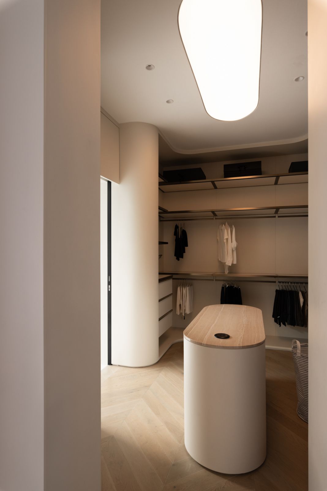 The walk-in wardrobe is softly curved