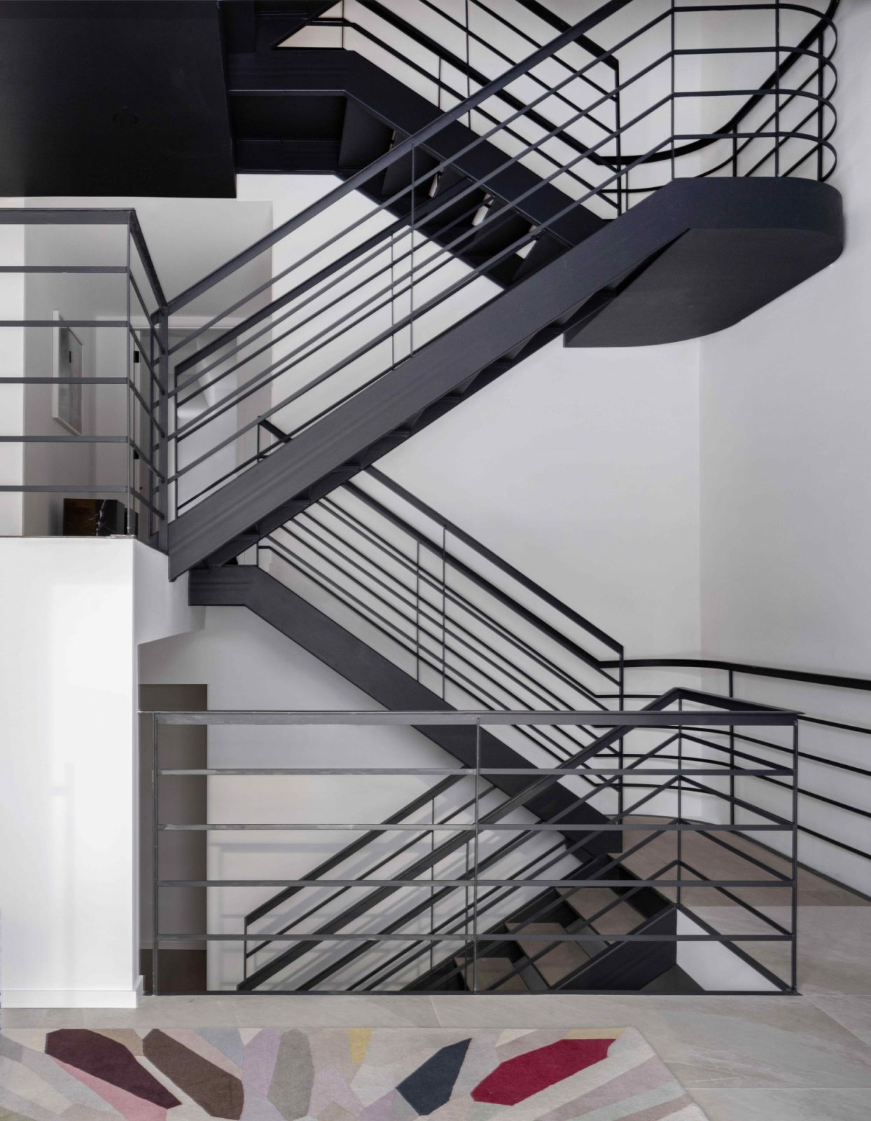 The five-storey black metal staircase is an industrial statement piece in the loft