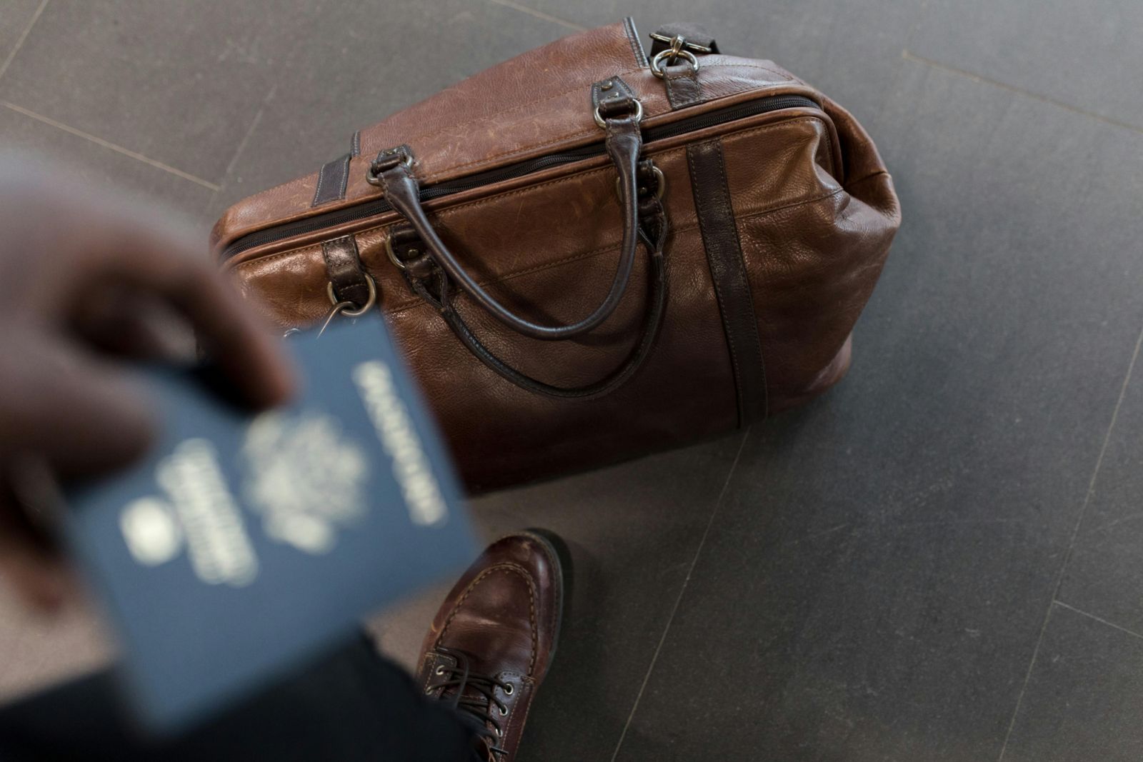 A passport on hand (Photo: Nappy / Pexels)