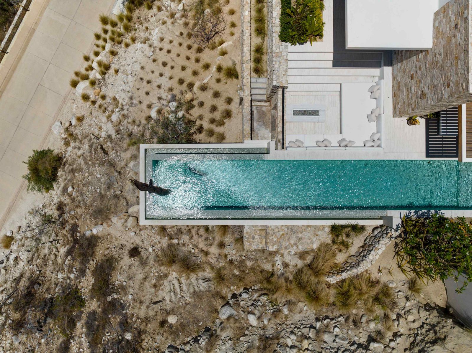 The 4,000-square-foot outdoor swimming pool that runs parallel with the entire home