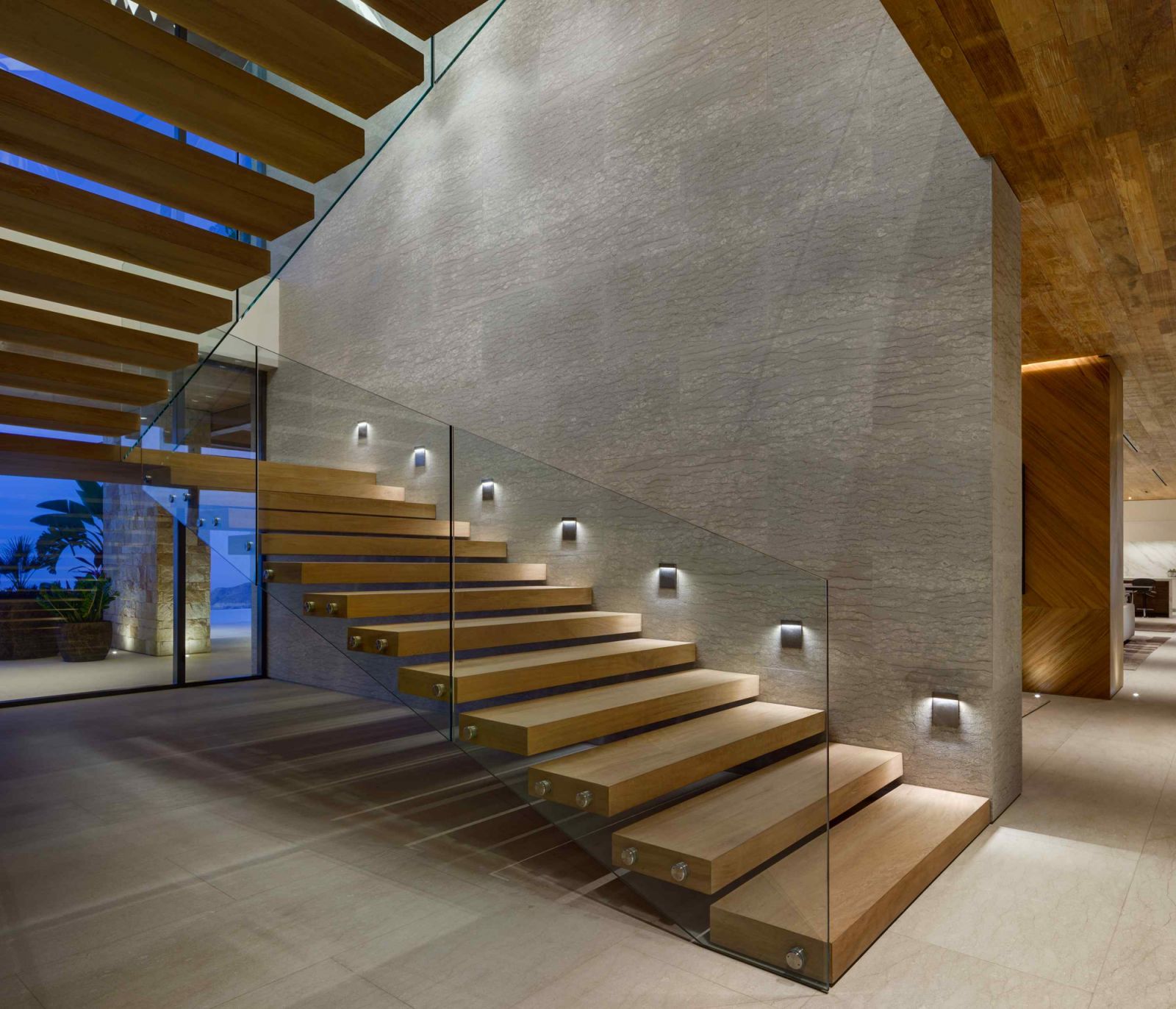 Lineal floating ramps in lieu of a conventional stairway towards the upper level