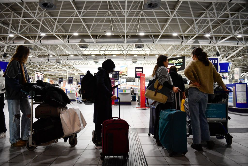 TURIN, ITALY - DECEMBER 22: People waiting with suitcases for departure at Turin airport for Christmas holiday destinations on December 22, 2023 in Turin, Italy. (Photo by Stefano Guidi/Getty Images)