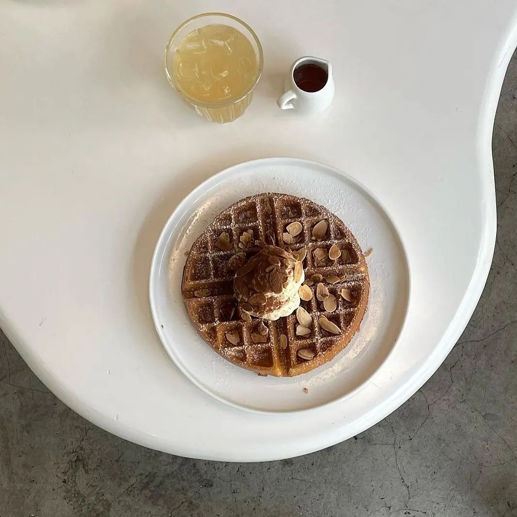 A classic waffle with homemade ice cream, caramel, and almond slices (Photo: Instagram / @afterone.kl)