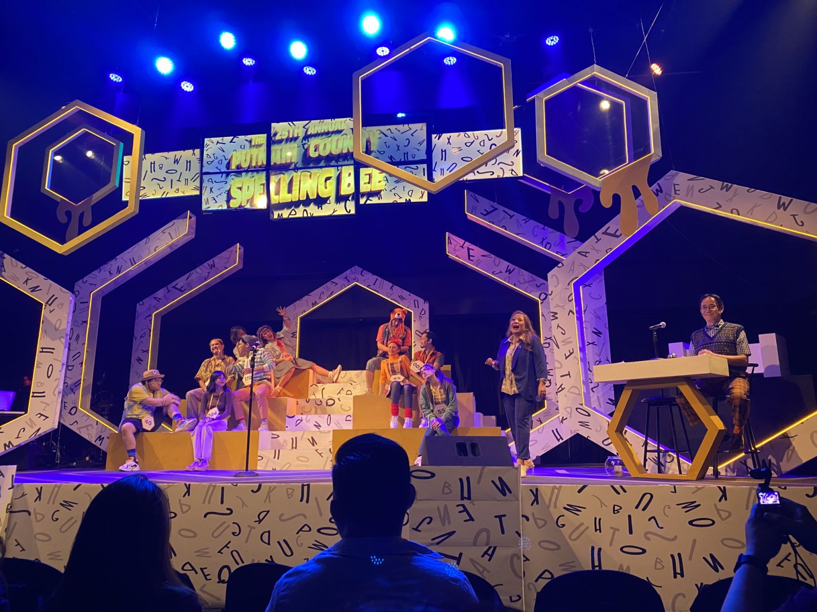 The cast members with guest spellers on stage