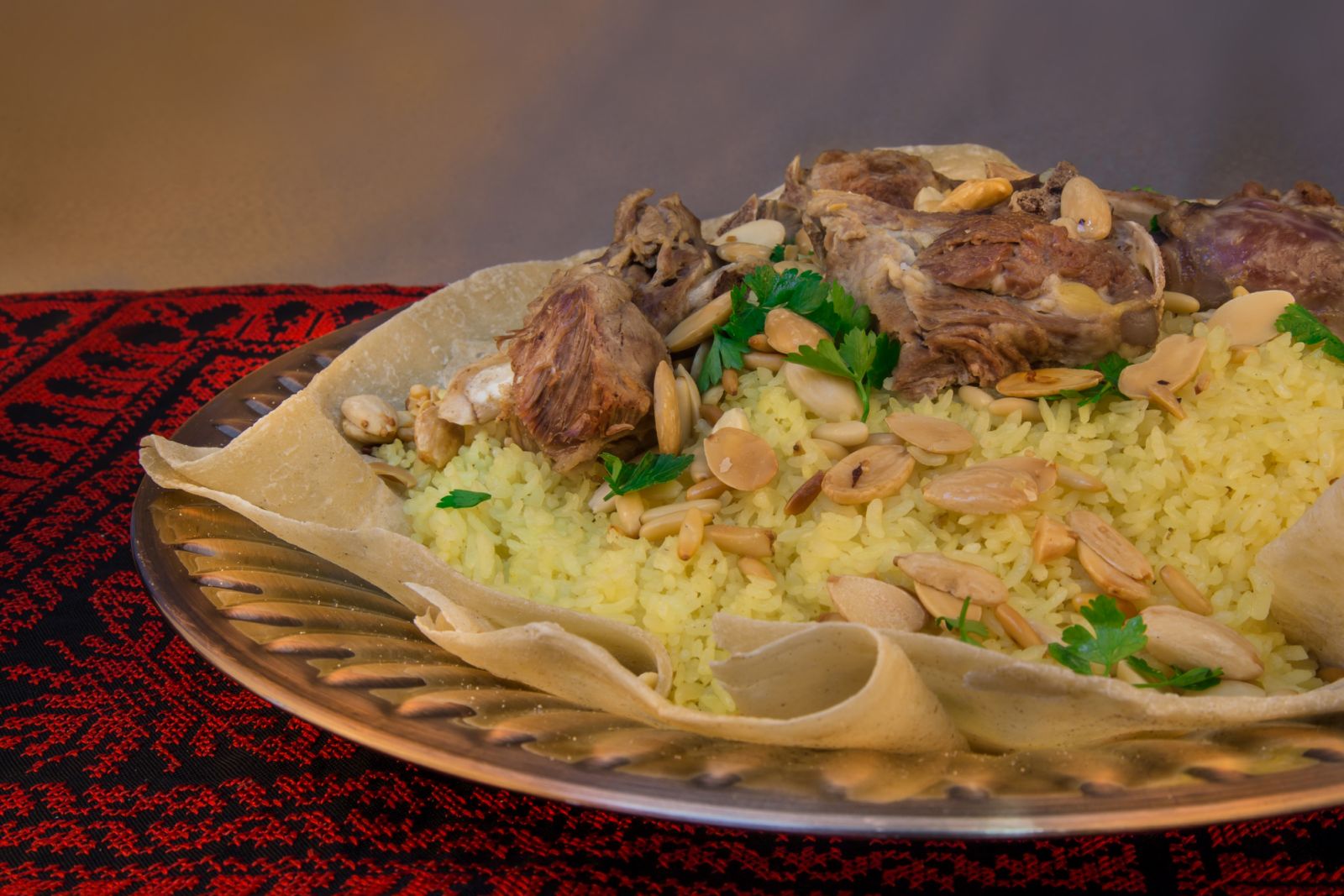 Jordanian mansaf topped with sliced nuts (Photo: Getty Images)