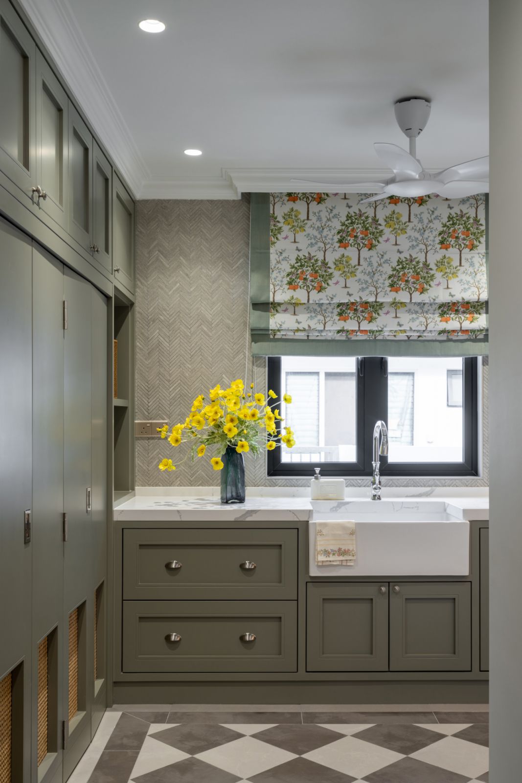 Olive coloured built-ins juxtaposed with checkered flooring