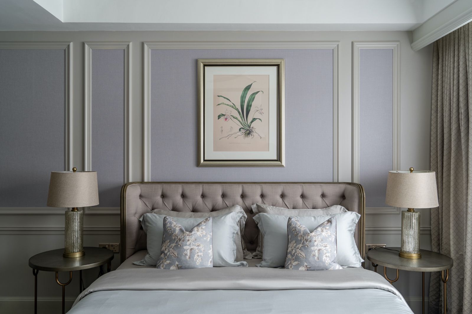 This bedroom portrays a restful tableau with its plush mix of neutral-toned fabrics and soft furnishings