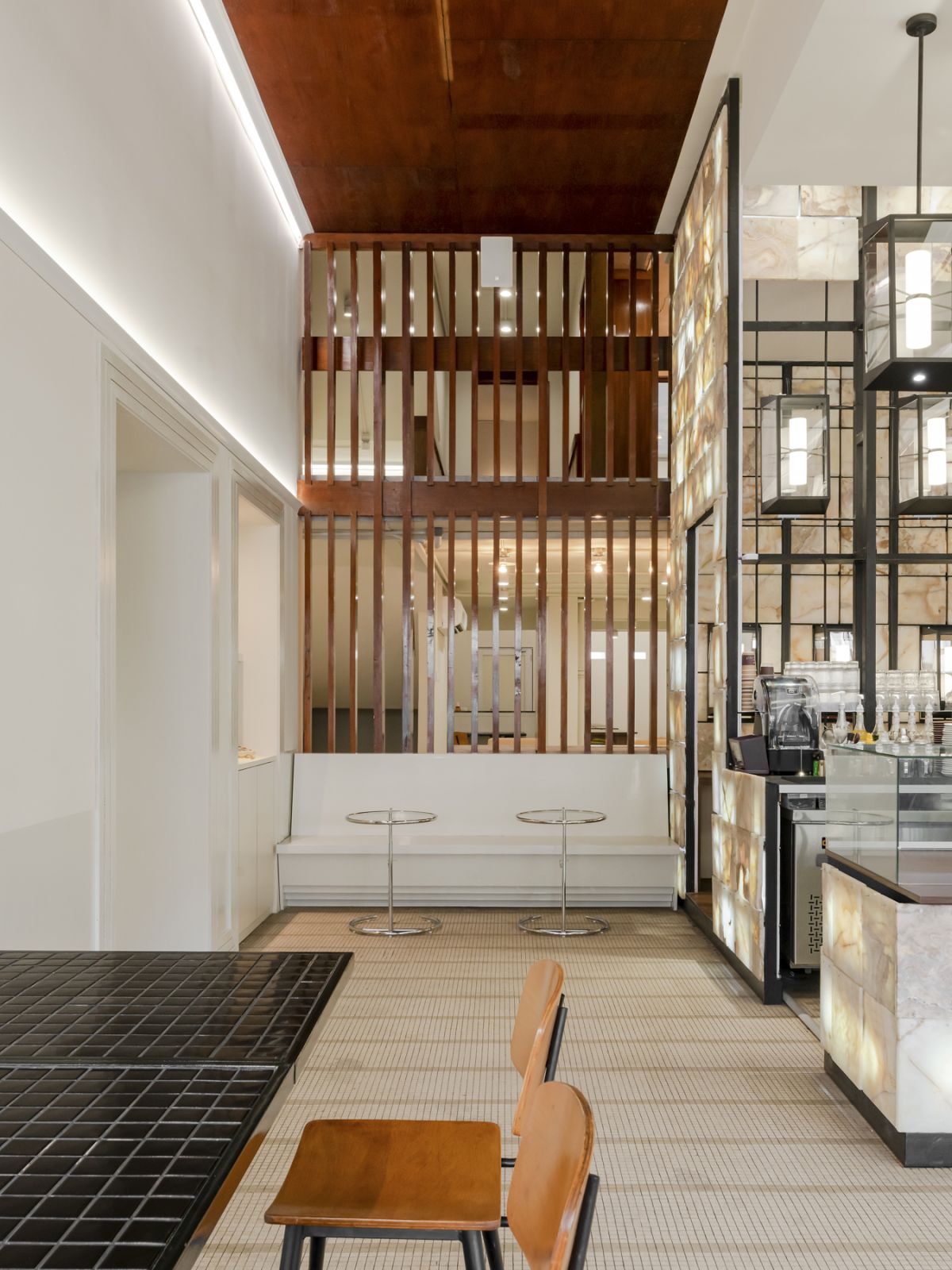 Salvaged wood louvres act as dividers between the front and back