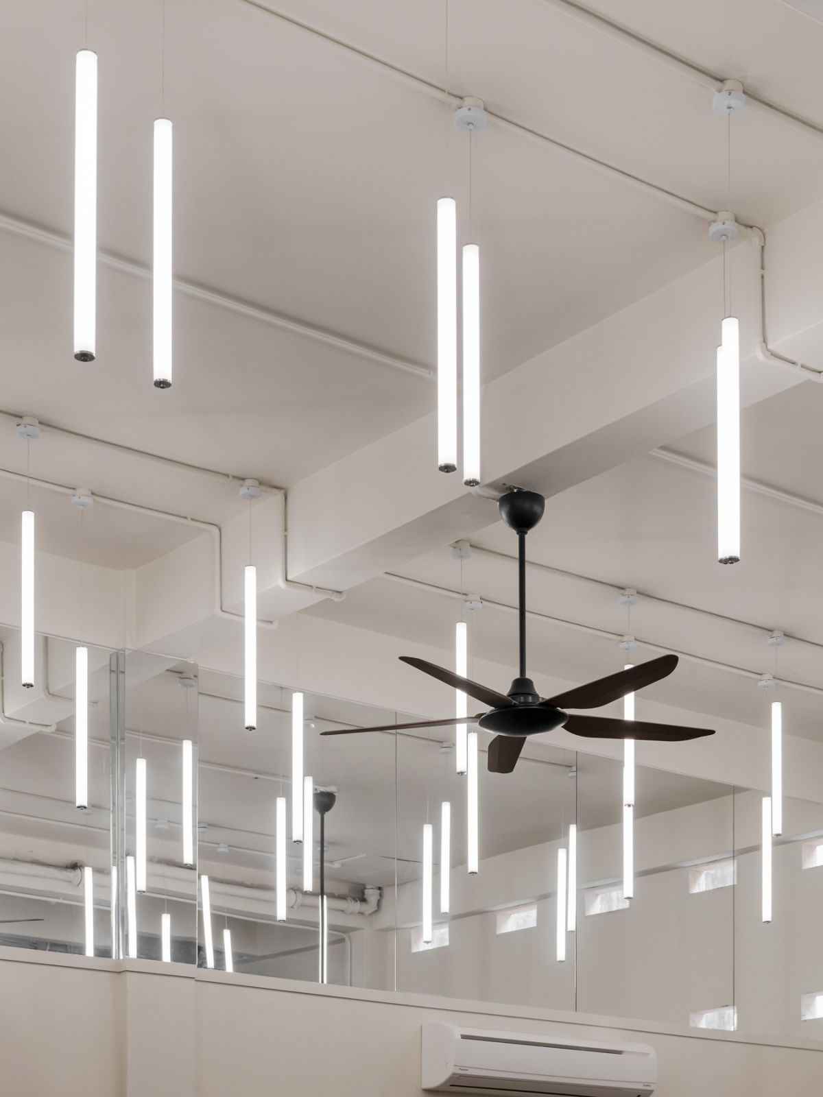 Symmetrically hanging light tubes that resemble floating candles