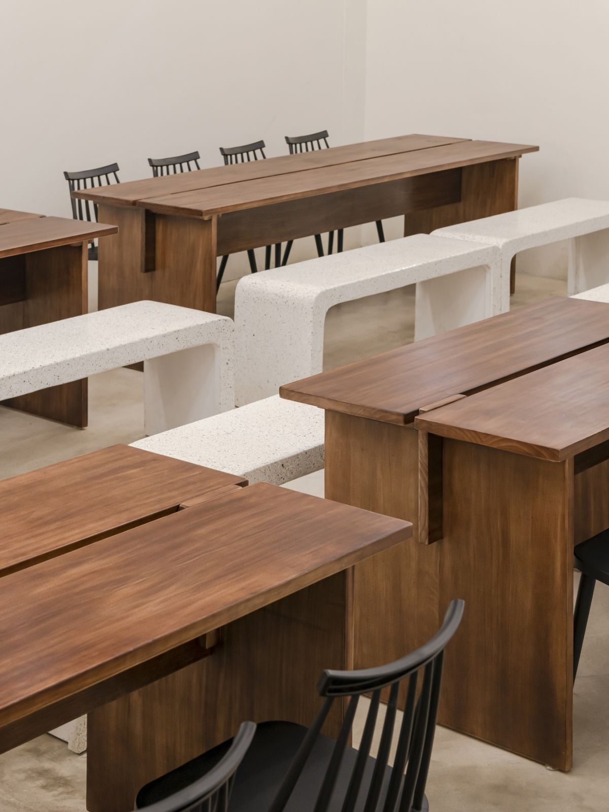 Long walnut dining tables with stone carved benches