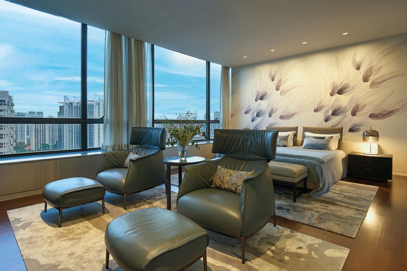 The master suite provides supreme comfort in the form of Archibald armchairs and ottomans from Poltrona Frau, while a custom wallcovering designed by Emma Hayes lends an organic touch