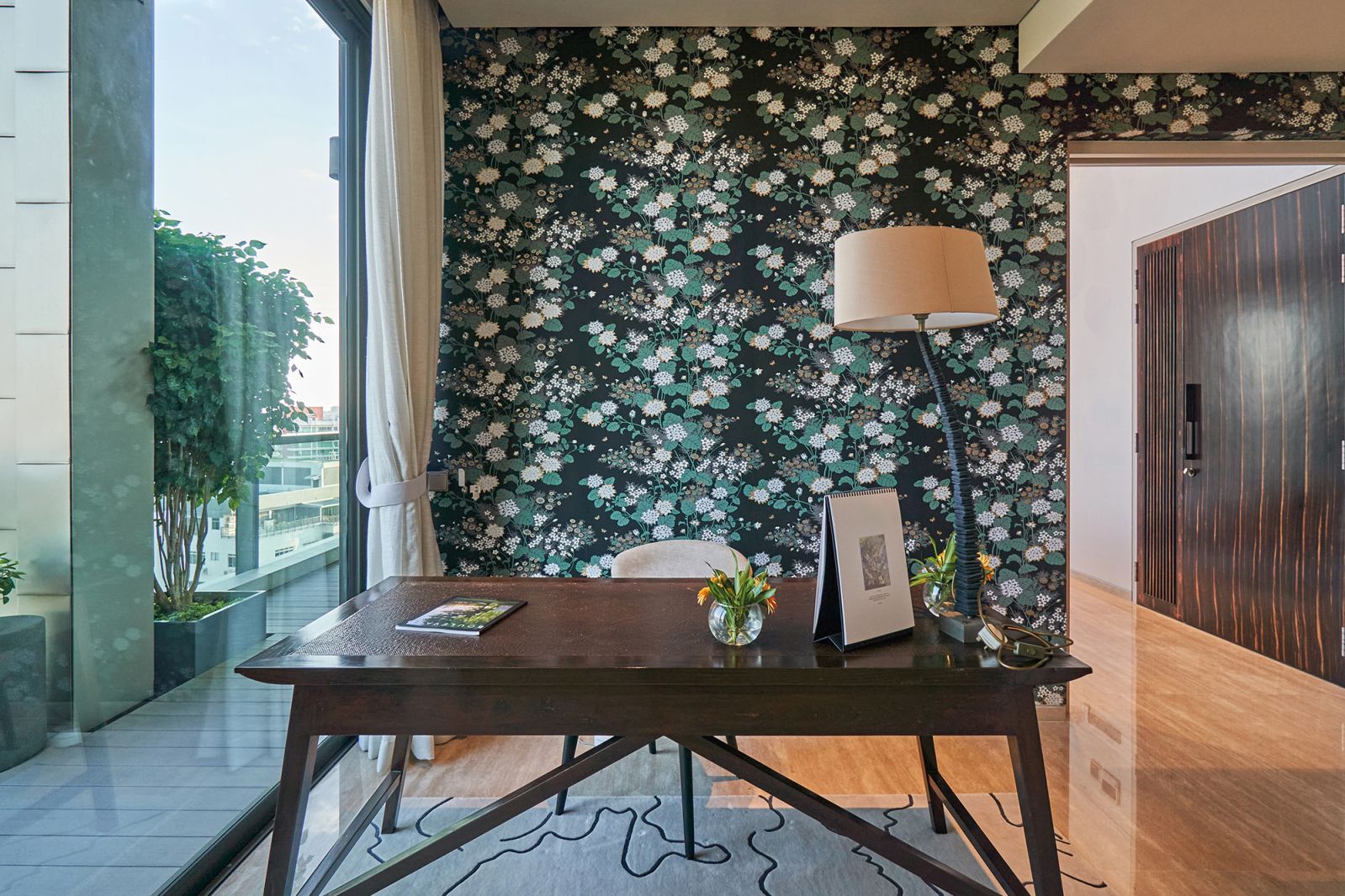 In the study, wallpaper from Florence Broadhurst creates a sense of whimsy and makes an artistic statement