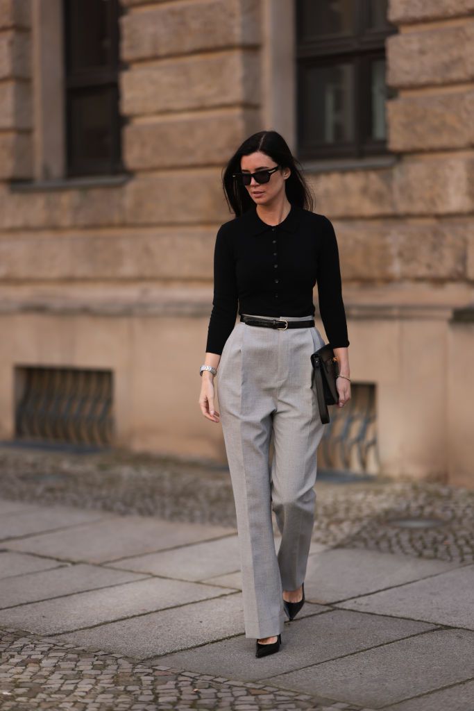 BERLIN, GERMANY - FEBRUARY 25: Leo Eberlin seen wearing Bottega Veneta black sunglasses, Leo Mathild jewelry / diamond bracelet and rings, Allude x Leo Mathild cashmere wool knit buttoned body, Toteme black leather belt, Velaa light grey elegant suit pants, Rolex silver watch, HermÃ¨s black leather clutch bag and Saint Laurent black varnished leather heels / pumps, on February 25, 2024 in Berlin, Germany. (Photo by Jeremy Moeller/Getty Images)