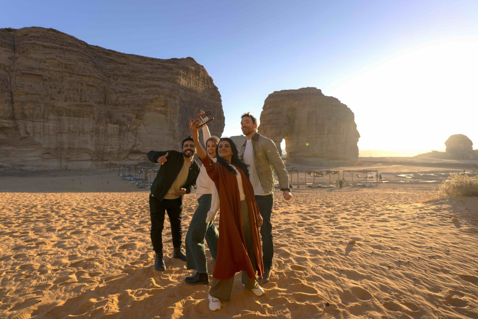 A group of friends in Western dress capturing a selfie together near Elephant Rock