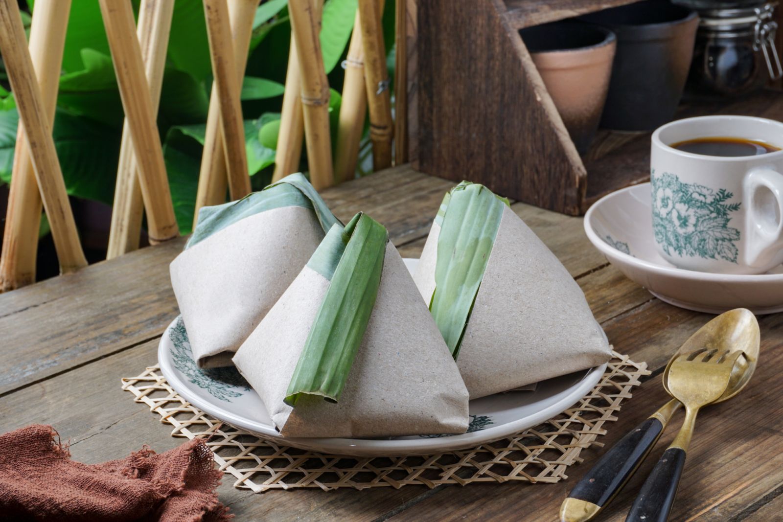 Asian cuisine Nasi Lemak is a rice dish infused with coconut milk. Wrap in banana leaf and brown paper.