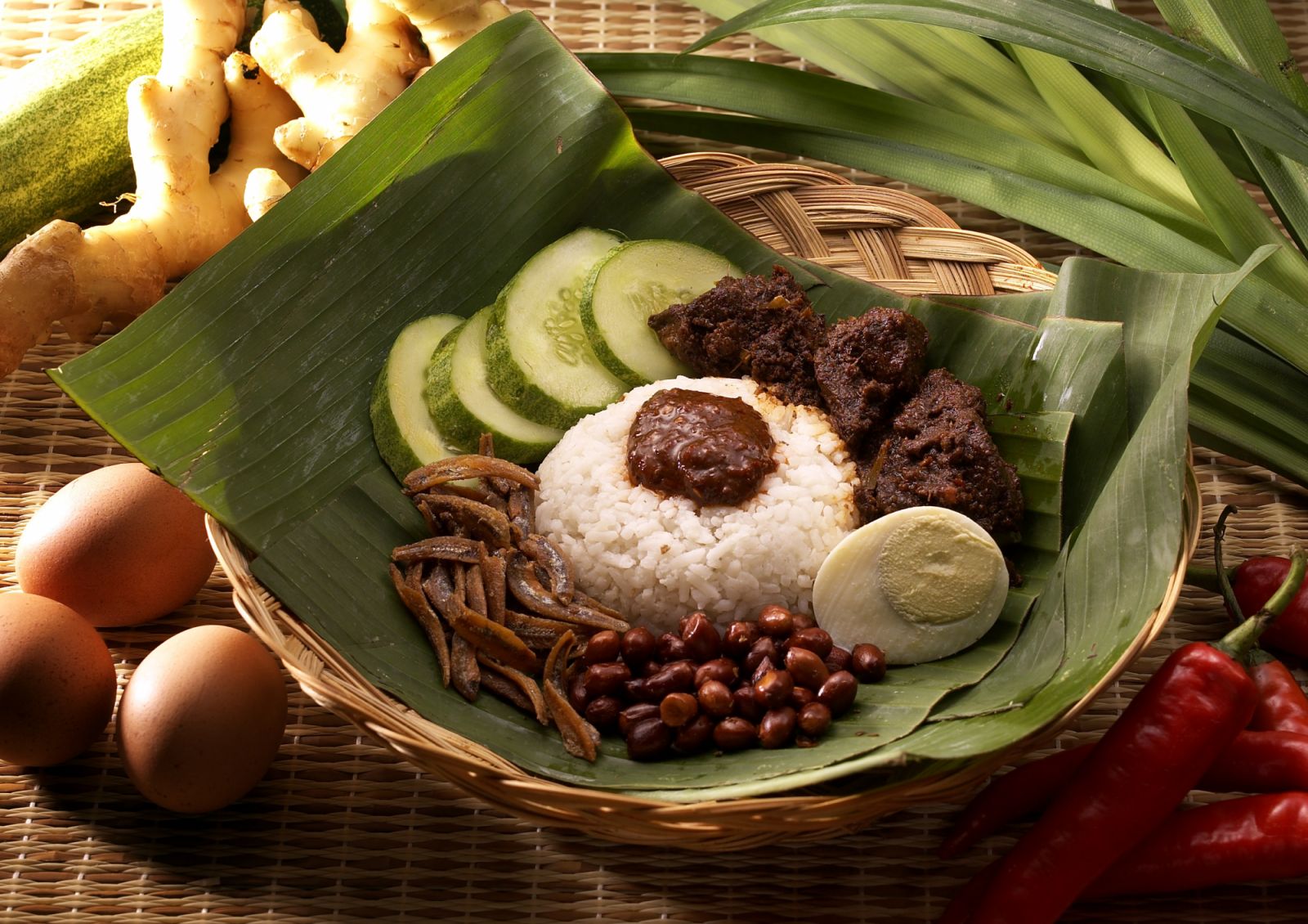 Nasi lemak is a dish that is commonly sold in Malaysia, Brunei and Singapore. In fact, it has been called the unofficial national dish of Malaysia. The dish comes as a platter with cucumber slices, small dried anchovies (ikan bilis), roasted peanuts, stir fried water convolvulus (kangkong), hard boiled egg, pickled vegetables (achar) and hot spicy sauce (sambal).