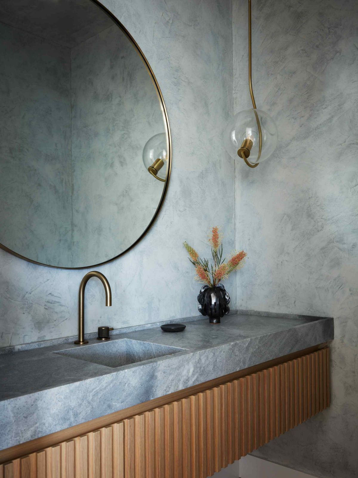 Hand plastered walls in the powder room with a statement light pendant