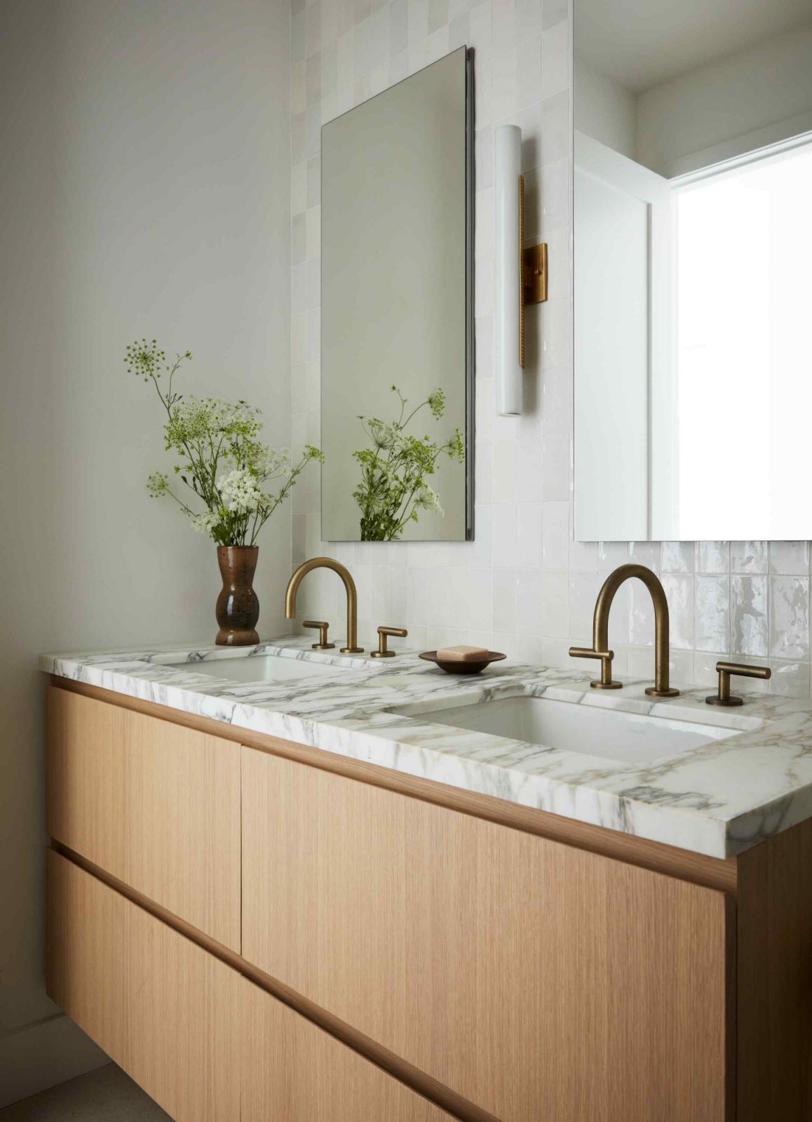 Marble and zellige tiles paired with warm wood and brass accents
