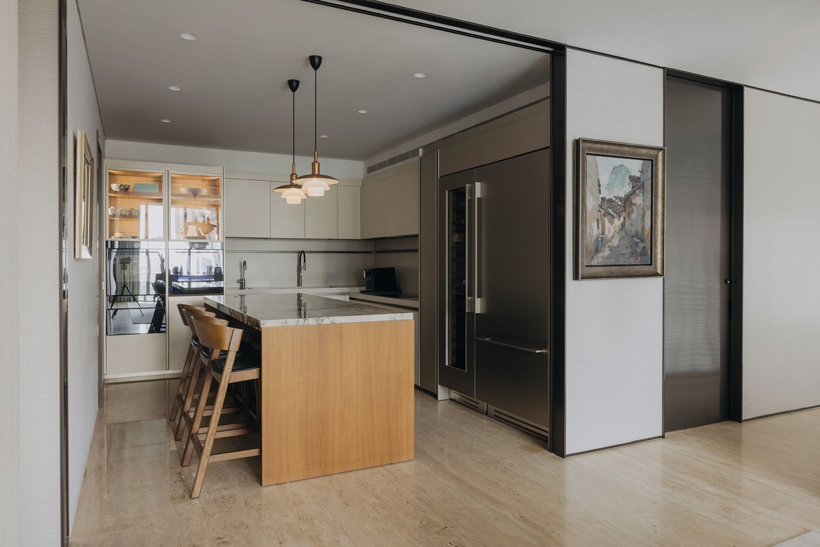 Pendant lamps from Louis Poulsen add designer flair to the kitchen, a well-composed space with various appliances located within arm’s reach